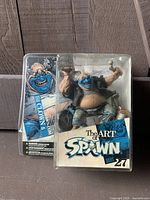 Front view of The Art of Spawn Series 27 clown figurine in original packaging showing character and branding.