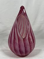 Front view of pink swirling glass vase with teardrop shape and elongated opening.