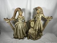 Pair of vintage Victorian lady and gentleman chalkware statuary sculptures, front view.