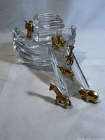 Crystal Noah's Ark with gold animal pairs arranged on and around it; three animal figures detached.