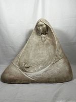 Full view of La Madre ceramic sculpture showing the mother figure cradling a child in a triangular form with a distressed finish.