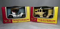 Two Matchbox Models of Yesteryear cars side by side in their original branded boxes, showing front and side details.