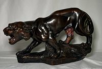 Front view of full tiger sculpture showing overall form and bronze-like finish