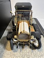 Front view of the 1912 Packard Victoria model showing detailed grille, headlights, and gold trim.