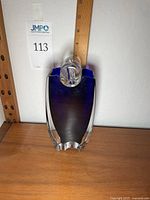 Front view of assembled vase with clear flower holder and ruler for scale