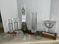 Photo showing all crystal and glass items including vases, decanter, face sculptures, candy dish, glass birds, and art glass lamp all displayed in a single view.