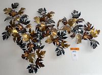 Front view of entire sculpture mounted on wall showing leaf arrangement and color variety
