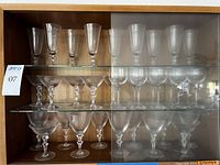 Three-shelf cabinet view combining knobbly-stem flutes, coupes and goblets