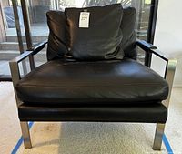 Front view of armchair showing cushions and frame