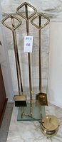 Full set of three brass fireplace tools on glass base and brass lidded fire starter holder