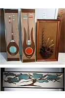 Three vertical wood panels by RanSu (two with stylized lutes, one with floral pinecone relief) leaning against wall, plus horizontal metal tree art below