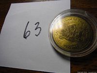 Photo showing the gold-colored commemorative coin inside a protective plastic case with the inscription 'Canada's Team of the Century 1900-2000' visible.