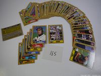 Photo of arranged 1987 Topps baseball cards including front views of Alan Trammell, Robin Yount, Doug Corbett, Ben Oglivie, Greg Gagne, Mark Bailey, and Don Robinson cards.
