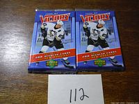 Two unopened 2006-07 Upper Deck Victory hockey card packs with a hockey player in a Pittsburgh Penguins uniform on the front.