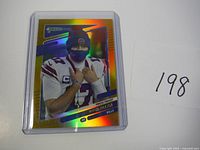 Front of the 2021 Josh Allen football card showing holographic finish with Josh Allen wearing no helmet but a mask.