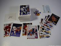 Stack and spread of 1990-91 Upper Deck hockey cards showing players from multiple NHL teams, including some star and rookie cards.