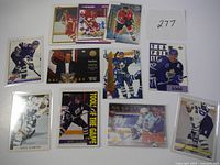 Photo showing 11 Doug Gilmour hockey cards laid out on a white surface, featuring various card designs and poses including Toronto Maple Leafs and Calgary Flames uniforms.