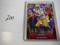 Front view of 2020 Joe Burrow Leaf Draft rookie card showing him in LSU uniform in game action.