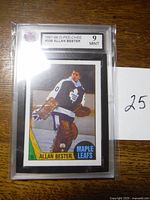 Front view of the graded 1987-88 O-Pee-Chee Allan Bester hockey card in protective plastic, showing player in Toronto Maple Leafs uniform and grade label 9 Mint.
