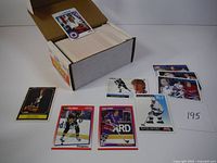 Image showing a box of multiple 1991 Score hockey cards with various individual cards displayed on top, including players like Mario Lemieux and others.