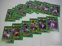 Overview image showing 18 2024 Score football cards laid out with green bat parallel design borders.