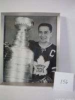 Framed black and white photo showing Maple Leafs captain with Stanley Cup trophy.