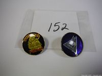 Two collectible pins; Budweiser pin with golden eagle and 'This Bud's For You' text, and purple Def Leppard band pin with logo.