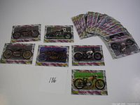 Twenty-one sealed collectible cards featuring vintage motorcycles from American Vintage Cycles, arranged on a flat surface.