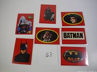 Seven various Batman-themed OPC hockey cards laid out on white surface, front faces showing characters and logos.