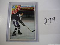 Front of vintage Darryl Sittler hockey card in plastic sleeve, showing player image and team logo