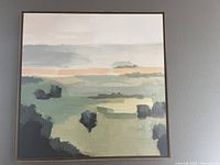 Framed abstract landscape painting with muted greens, greys, and a strip of soft orange across the middle under a cloudy sky. Square format, 33x33 inches.