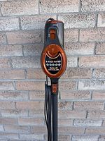 Front close-up view of vacuum cleaner showing 5-star energy rating label and power button on the main body.