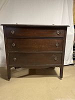 Full front view of the vintage wooden dresser showing three drawers and overall condition.