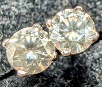 Close-up of two round brilliant diamonds in four-prong white gold settings