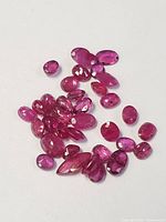 Loose rubies with various sizes and cuts displayed on white background