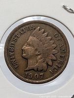 Obverse of 1907 Indian Head Cent showing date and UNITED STATES OF AMERICA legend