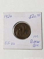 Obverse and reverse of coin inside 2x2 flip showing date and denomination