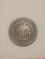 Obverse of 1868 Shield Nickel showing shield design and date