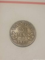 Reverse of 1934 Canadian one-cent coin showing CANADA ONE CENT and maple leaves