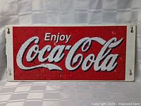 Full view of metal Coca-Cola sign front