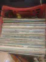 Top view of milk crate filled with stacked vinyl LP records