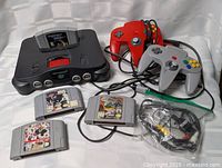 Full lot view: console, controllers, games, cables