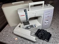 Overview of machine, case, extension table, foot pedal and accessories tray