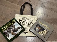 Photo showing both Robert Bateman books and the canvas tote bag positioned on the floor.