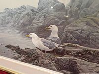 Close-up view of print showing two seagulls on rocky coastal scene