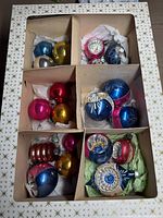 Boxed set of assorted vintage mercury glass ornaments, showing variety of colors and styles.