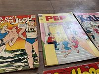 Front covers of four vintage comic books including A Date with Judy, Pep, Kathy, and Millie
