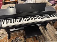 Front perspective of piano on stand with bench