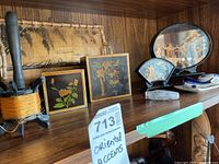Wide view showing the wooden boxes, bamboo tray, miniature scenes under glass, and small porcelain dish on a wooden shelf.