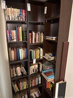 Photo of bookshelves filled with various books arranged vertically and horizontally.